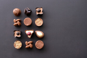 Delicious chocolate candies on black background