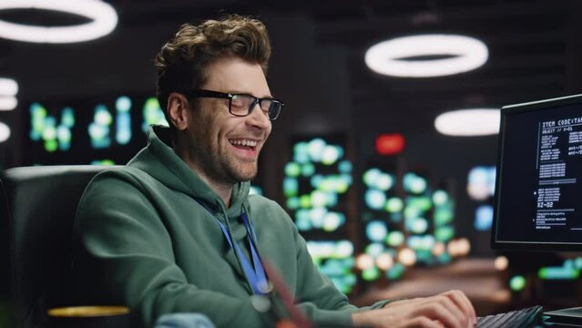 Laughing computer scientist working late datacenter closeup. Man typing keyboard