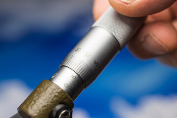 4K Ultra HD Close-Up Image of Metal Micrometer Against Blue Sky Background