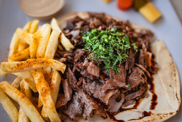 Fried meat with french fries. Shawarma with grilled beef and salad.
