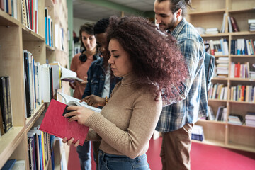 Students gather in the bustling college library, absorbed in books and collaborative study. The air...