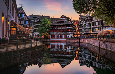 Ornate traditional half timbered houses with blooming flowers along the canals in the Petite France...