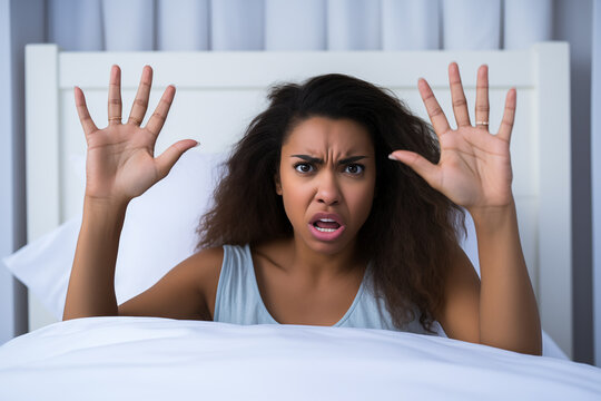 Skeptical woman showing open hands in bed, indicating number 10