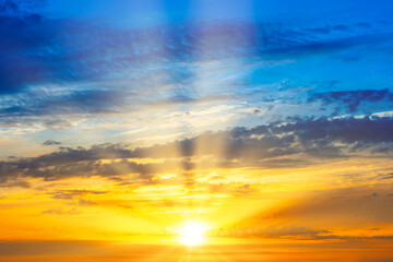 Sunset sky with sunset clouds, sun rays and dramatic sky