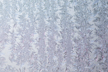 Pattern of ice frost on the glass of window. Winter background ant texture. Close up