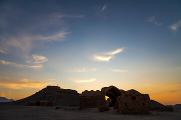 Sunset at ruins of Zoroastrian mudbrick structures next to their towers of silence in Yazd, Iran