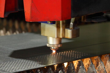 Laser cutting of metal sheet and punching holes on a CNC machine with flame on torch - obrazy, fototapety, plakaty