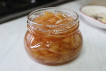 a jar of delicious apple jam on the kitchen table