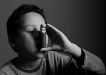 child with flu and inhaler respiratory puff on grey background with people stock photo  - obrazy, fototapety, plakaty