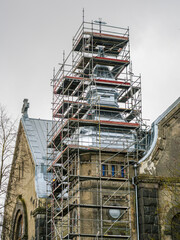 Tin roofing replacement of an old Lutheran stone church using complicated shape scaffolding
