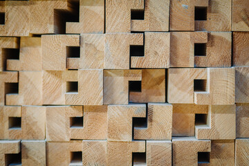 The image features a close-up view of a stack of wooden beams with a unique interlocking pattern.