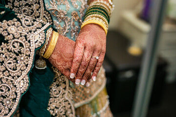 Indian bride's hands bangles and mehndi close up
