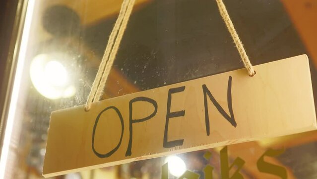 Wooden open sign showcased on shop counter