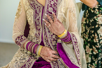 Indian bride's hands bangles and mehndi close up