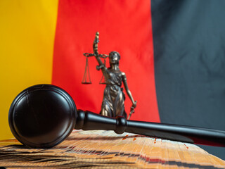 The judge's gavel lies on 50 euro bills against the background of the German flag. Law and justice...