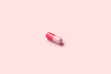 Medical capsule on pink background
