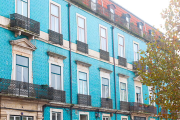Obraz premium Old colorful and beautiful facades in Lisbon streets in Autumn. The building in blue and brown colors is tiled with carved balconies. Villa Sousa.