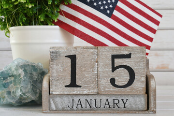 Martin Luther King Jr Day - wooden block calendar showing his birthday January 15 American flag - obrazy, fototapety, plakaty