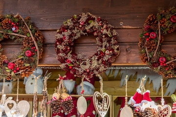 New Year's and Christmas holiday wreaths made of fir branches, snowman figures, and toys on an...