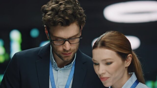 Confident IT admin talking colleague in data center closeup. Developers working