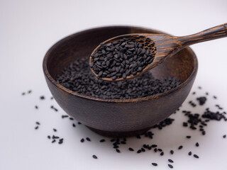 poppy on a wooden spoon And there is a portion of bong in a wooden cup. on a white background