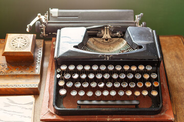 Ancient typewriter, old rusty typewriter on the wooden table.