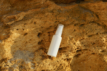 White mockup of jar of serum or face cream on yellow limestone. concept of beauty products