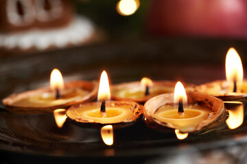 Christmas candles made of beeswax and nut shells floating in water