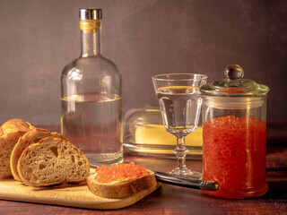 Antique-style still life with vodka and red caviar. - 701962700