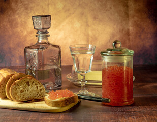 Antique-style still life with vodka and red caviar.