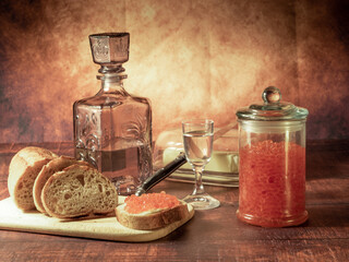 Antique-style still life with vodka and red caviar. - 701962765