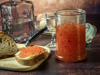 Antique-style still life with vodka and red caviar. - 701962768