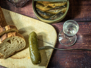 Antique-style still life with alcohol, vodka, canned fish, bread and cucumber. - 701962795
