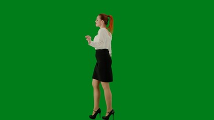Portrait of attractive office girl on chroma key green screen. Woman in skirt and blouse walking cutely. Side view.