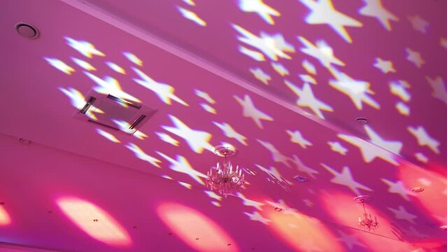 Party. Musical accompaniment. Rays from spotlights in pink in form stars. People are having fun. Colorful smooth template. Soft color background Color neon gradient