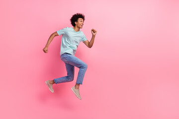 Fototapeta na wymiar Full size photo of nice young guy running fast shopping sales dressed stylish blue outfit isolated on pink color background