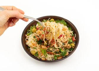 Stirring spaghetti with shrimp and vegetables