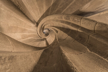 Bottom view of a historic spiral staircase.