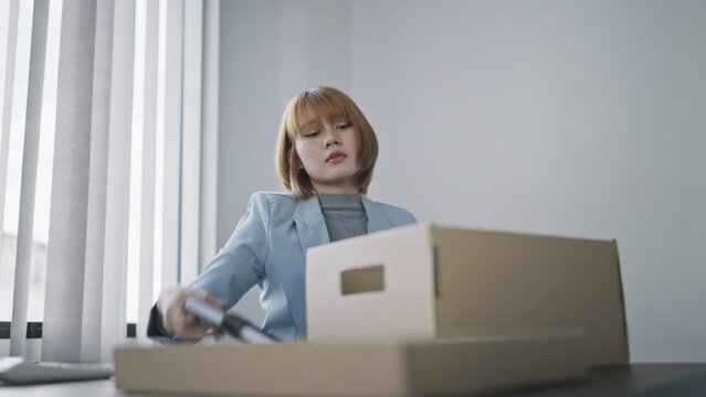 Resignation concept.Businesswomen packing Stuff with cardboard box for quit a job..