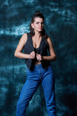 Young trendy woman posing in studio in denim style