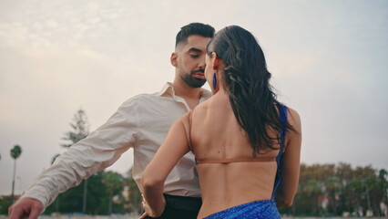 Hot woman moving partner performing sensual dance cloudy nature. Couple dancers