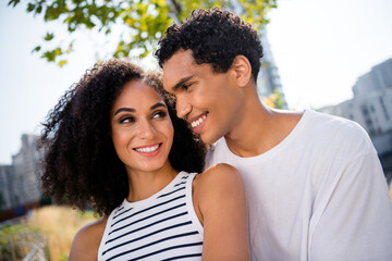 Fototapeta premium Photo of charming loving couple guy cuddle his beloved girlfriend in town park enjoy outdoors weekend