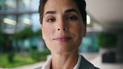 Closeup corporate woman posing at downtown center. Smiling relaxed businesswoman