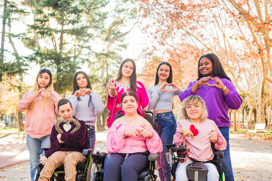 International womens day Inspire Inclusion multiethnic group do love heart with hands. Wheelchair