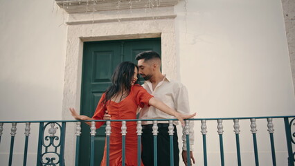 Sexy street dancers moving seductively near railing. Couple performing dance.