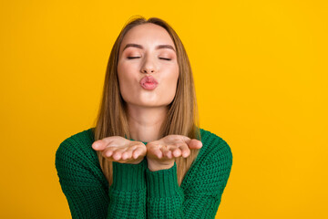 Portrait photo of young funny coquette lady wear green sweater plump lips closed eyes air kisses isolated on yellow color background - obrazy, fototapety, plakaty