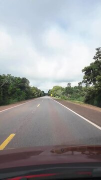 Dirigindo por uma rodovia na cidade de Corumb&aacute;, regi&atilde;o do Pantanal Sul, Estado do Mato Grosso do Sul, Brasil