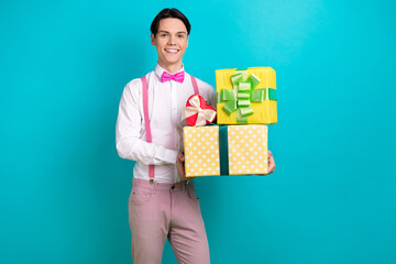 Photo portrait of attractive young man hold pile presents boxes celebration wear trendy pink clothes isolated on cyan color background