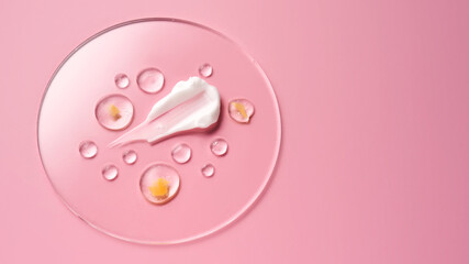 Gel, serum and a cream on a transparent round stand on a pink background.
