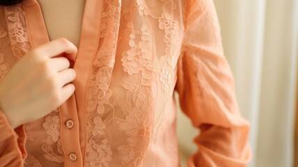 Closeup of a Peach Fuzz lace blouse, with a delicate lace collar and lace sleeves for a soft and romantic feel. - obrazy, fototapety, plakaty